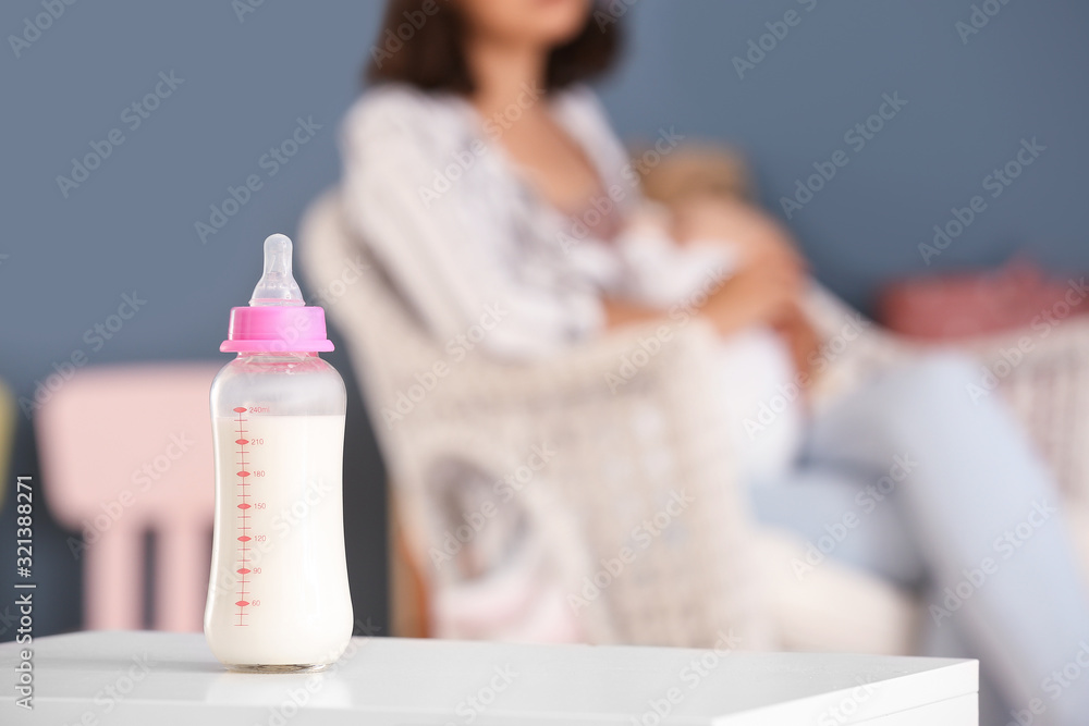 Bottle of milk on table in room Bottle of milk on table in room