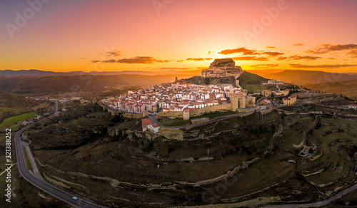 Aerial sunset view of Morella castle and town in central Spain with surrounding medieval walls, towers and winter festival photo