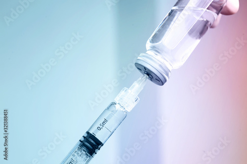 Syringe with filler for cosmetology and ampule on light background, closeup