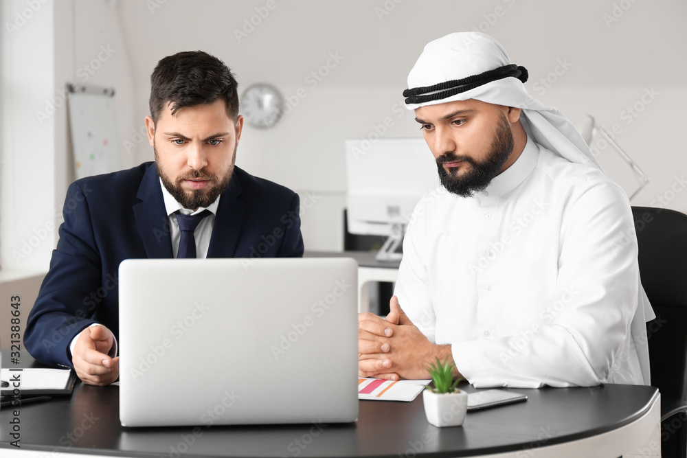 Arab man and his business partner in office Arab man and his business partner in office