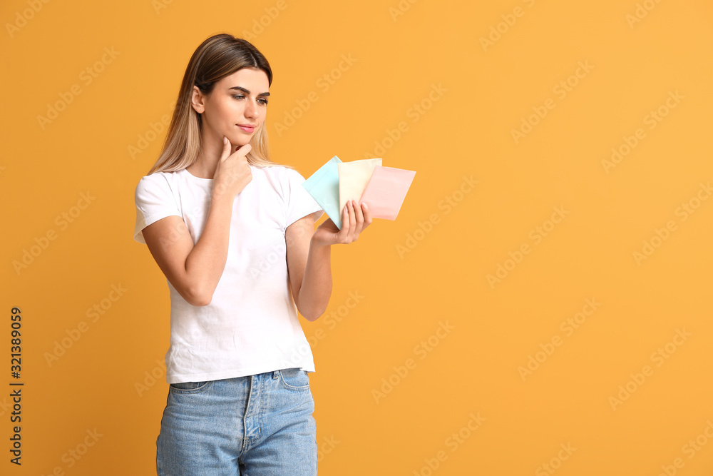Young woman with menstrual pads on color background Young woman with menstrual pads on color background