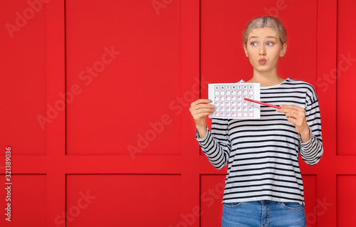 Young woman with calendar o...