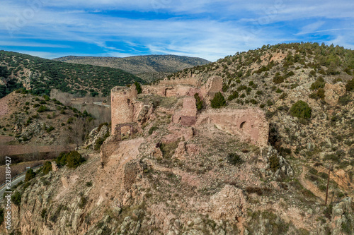 Aerial view of Santa Croche (Saint Cross) medieval castle ruin on the road to Albarracin Spain on a steep crag with a semi circular donjon and partially ruined embrasure  © tamas