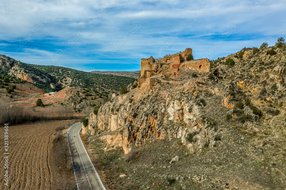 Aerial view of Santa Croche (Saint Cross) medieval castle ruin on the road to Albarracin Spain on a steep crag with a semi circular donjon and partially ruined embrasure Aerial view of Santa Croche (Saint Cross) medieval castle ruin on the road to Albarracin Spain on a steep crag with a semi circular donjon and partially ruined embrasure