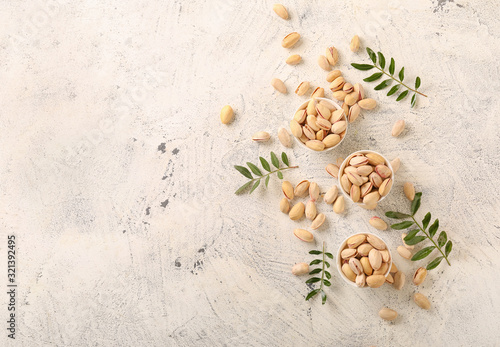 Wallpaper Mural Bowls with tasty pistachio nuts on light background Torontodigital.ca