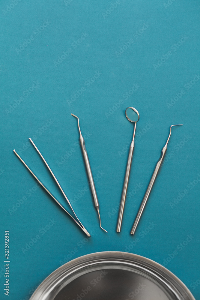 Dentist tools on a blue background top view Dentist tools on a blue background top view
