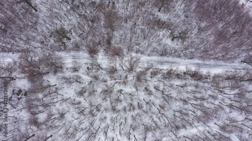 Railway and snowy woods in Hungary. Camera looks down and moves right. Drone footage Railway and snowy woods in Hungary. Camera looks down and moves right. Drone footage