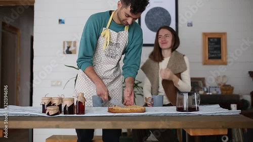 A couple in a country house having fun while eating breakfast.
