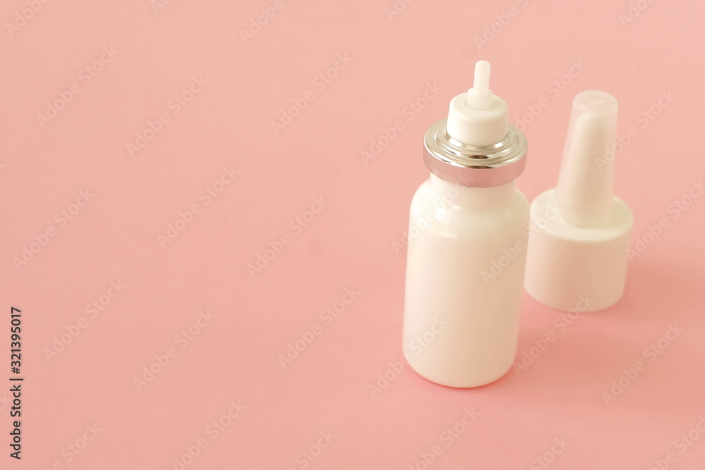 medicine bottle nasal spray on pink background with copy space medicine bottle nasal spray on pink background with copy space