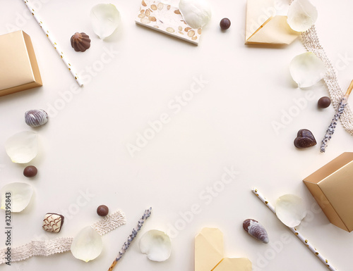 Valentines Day background. Rose,rose petals,chocolate,tube and ribbon beautiful. Isolated on Cream color background. Valentines day concept, View from above,There is a middle area on Cream color floor
