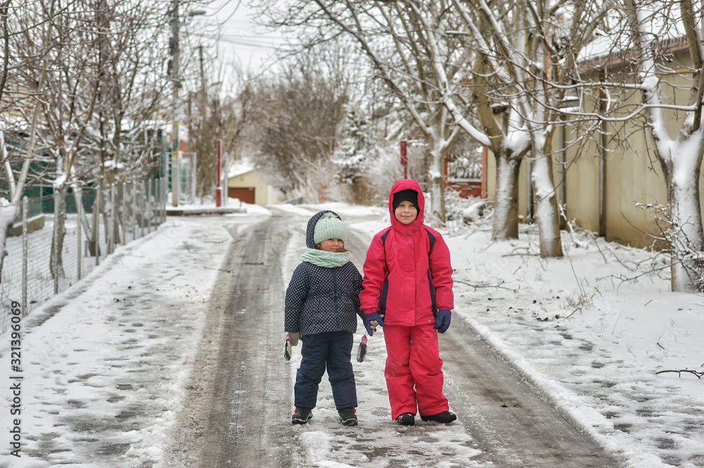 Children in warm clothes on a walk on a cold winter day