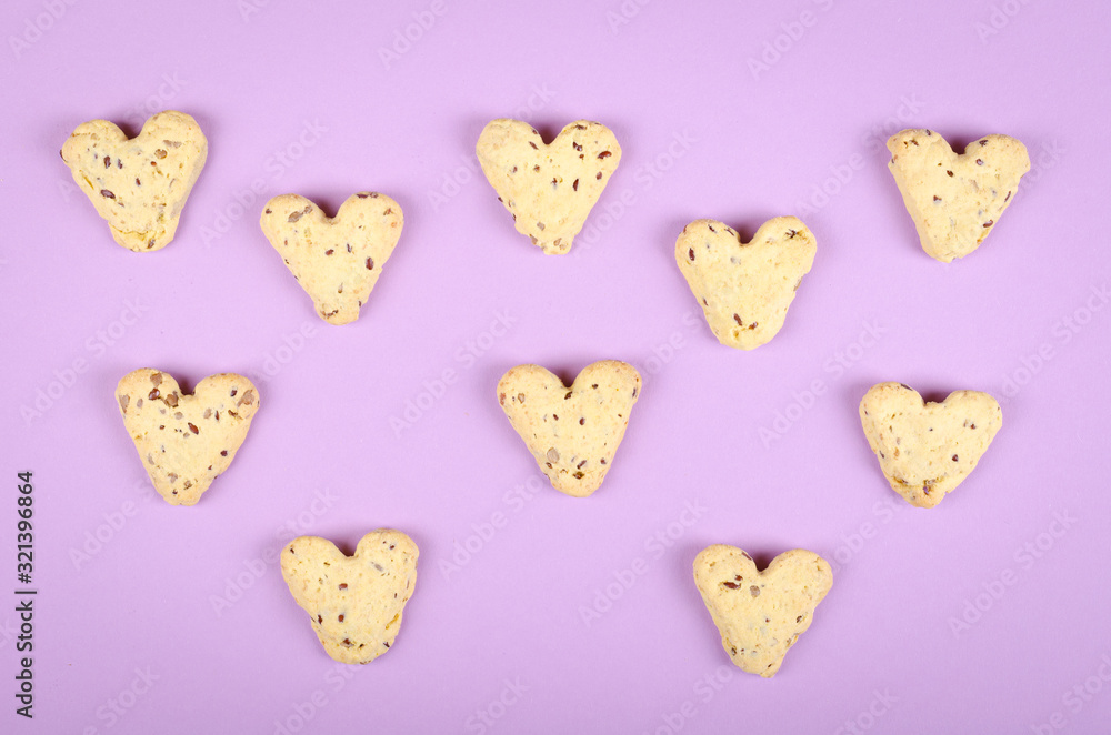 Flax seed cookies on purple background composition, heart shape. Flax seed cookies on purple background composition, heart shape.