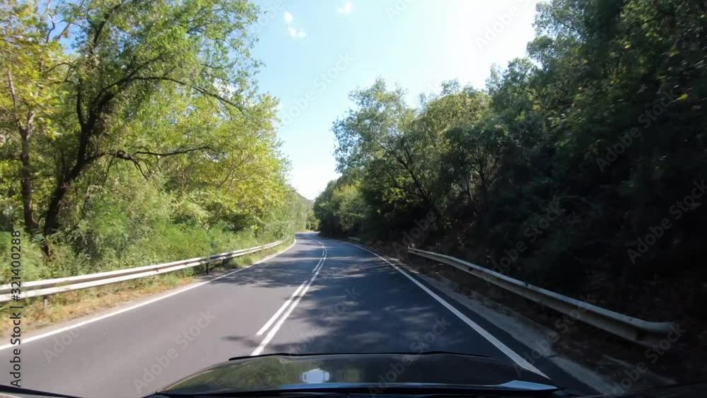 Summer road trip, first-person view of a moving car on a road, natural landscape on sunshine, sunlight, forest road. Summer road trip, first-person view of a moving car on a road, natural landscape on sunshine, sunlight, forest road.