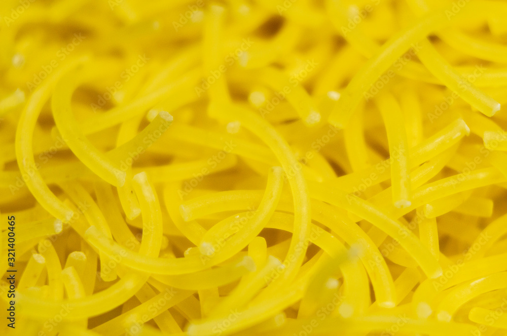 Yellow small pasta close-up. Macro photo Yellow small pasta close-up. Macro photo