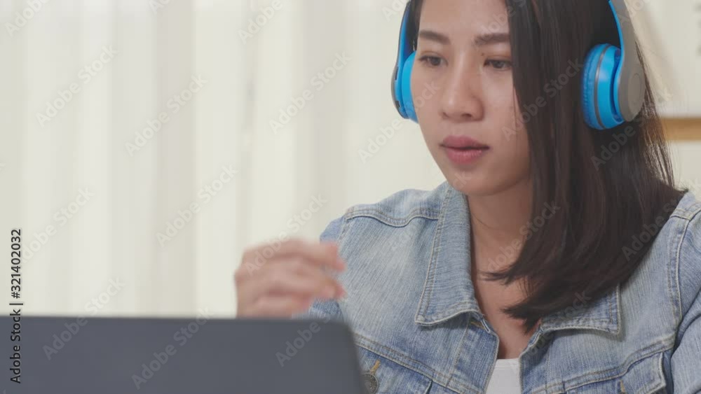 Asia freelance business women casual wear using laptop working call video conference with customer in workplace in living room at home. Happy young Asian girl relax sitting on desk do job in internet. Asia freelance business women casual wear using laptop working call video conference with customer in workplace in living room at home. Happy young Asian girl relax sitting on desk do job in internet.