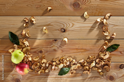 dried and fresh apples on a wooden surface