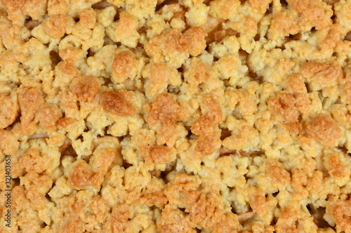 Cake topping crumbles on European Apple pie, close up