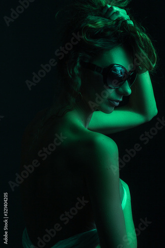 High Fashion model woman in colorful bright lights posing, portrait of a beautiful girl. Artistic colorful design. Party concept