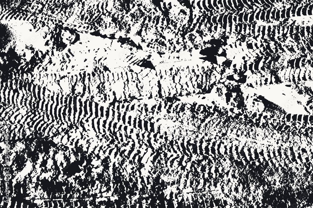Black and white texture of the earth with traces of car wheels. Abstract background with dark spots and traces.