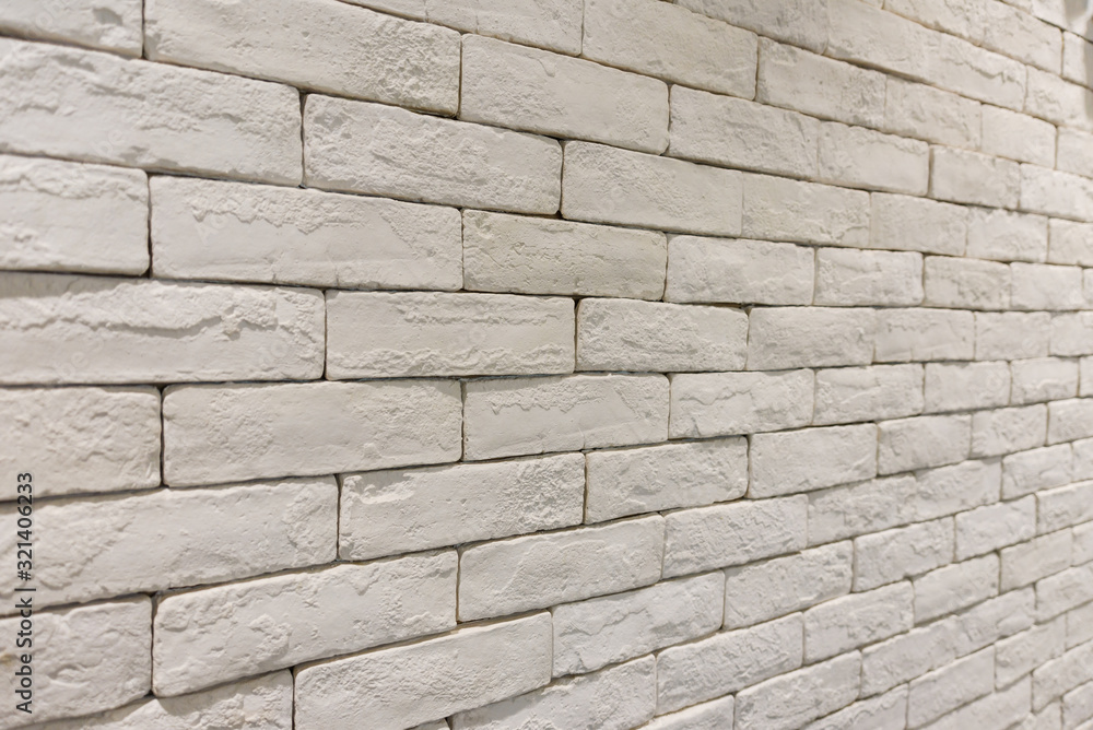 side view of empty white brick wall in room. textured and background