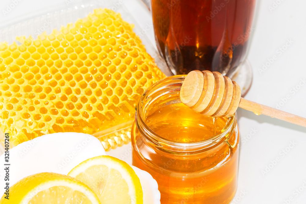 Tea with lemon and honey. The honey in the comb. Tea with lemon and honey. The honey in the comb.