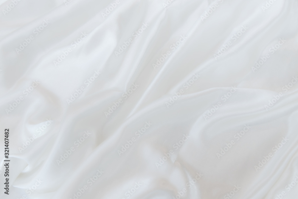 abstract background or texture of rippled white silk fabric lines