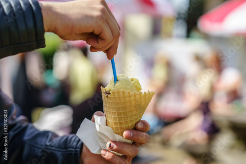 Photography Man holding ice cream cone. Detail of ice cream in hand