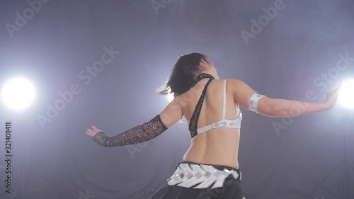 Young beautiful woman dancing belly dance