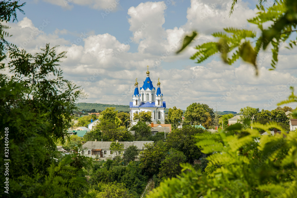 orthodox church Eastern European architecture religion building exterior facade rural landmark view spring time green foliage nature frame foreground orthodox church Eastern European architecture religion building exterior facade rural landmark view spring time green foliage nature frame foreground