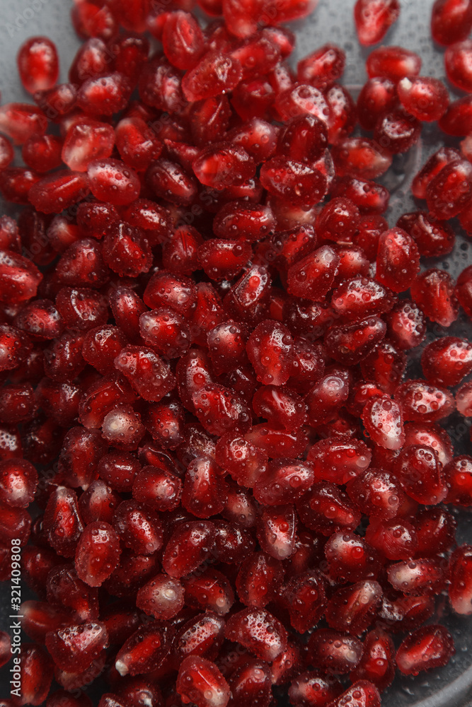Pomegranate seeds with water drops. Texture for the background. Ripe berries of pomegranate. Red texture of the granules in the macro. Pomegranate seeds with water drops. Texture for the background. Ripe berries of pomegranate. Red texture of the granules in the macro.