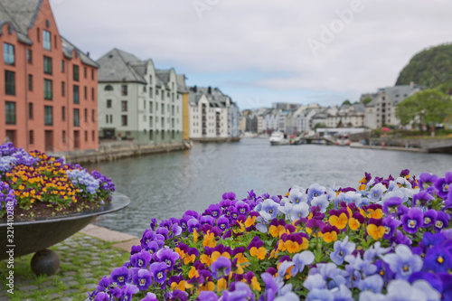 Alesund old town seafront view with Art Nouveau style houses and blooming colorfull flowers © Jiri Vondrous