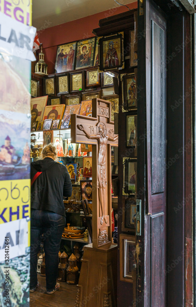Naklejka premium Religious items for sale in a small street shop on Kote Afkhazi St in the old part of the Tbilisi city in Georgia
