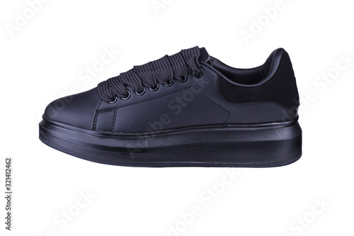 One black sneaker on a white background. Sport shoes.