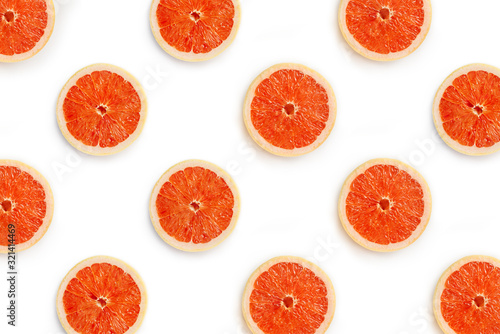 Halves of grapefruit on a white background. Symmetrical background from pieces of red grapefruit staggered.