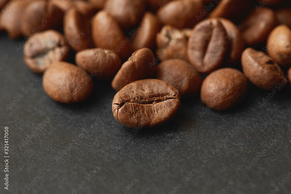 Roasted coffee beans isolated in dark background. Espresso dark, aroma, black caffeine drink. Roasted coffee beans isolated in dark background. Espresso dark, aroma, black caffeine drink.