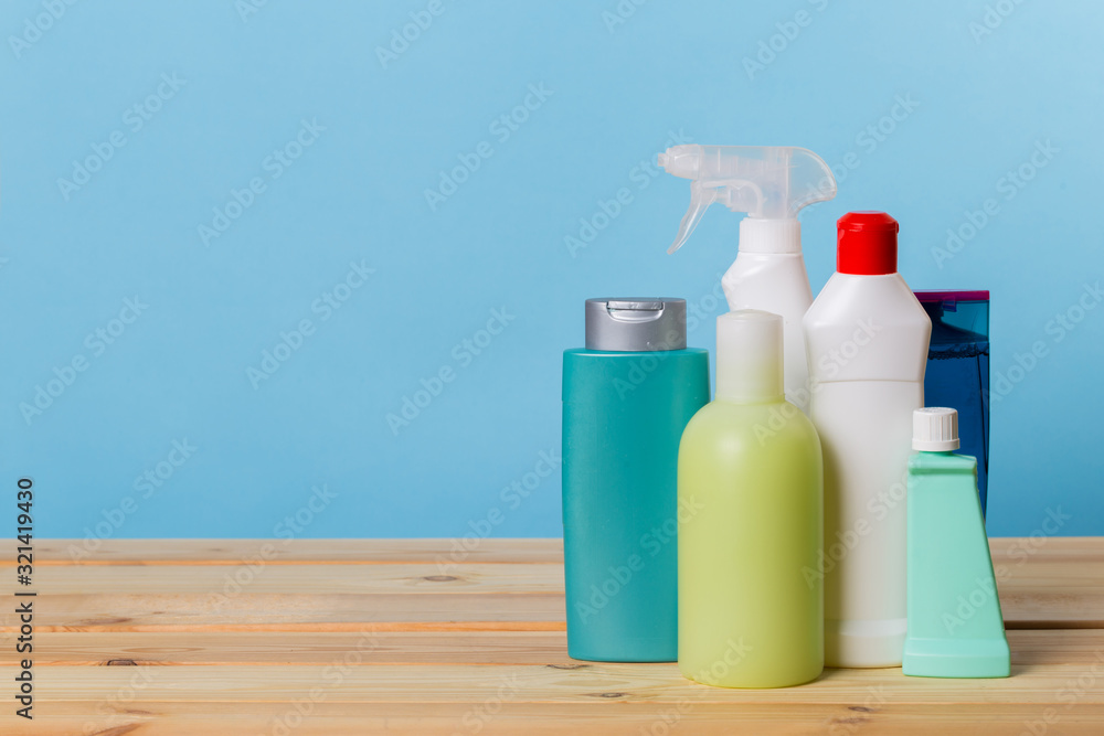 Cleaning product plastic container for house clean on wooden table and blue background . household chemicals Cleaning product plastic container for house clean on wooden table and blue background . household chemicals