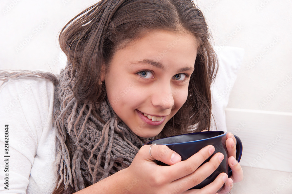 The girl is ill, drinking tea The girl is ill, drinking tea