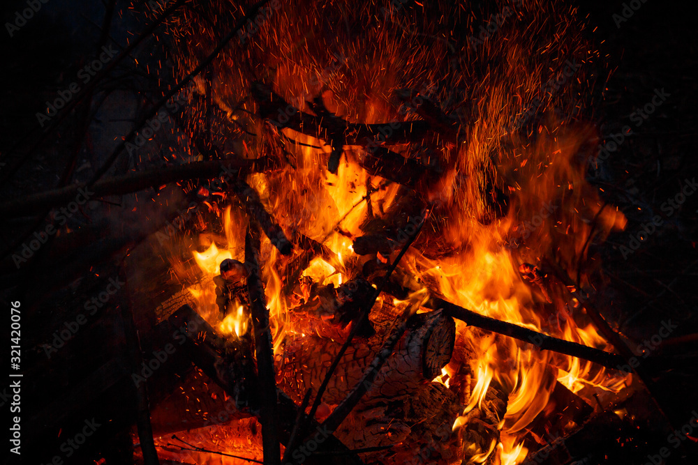 Campfire flame with sparks flying up at night Campfire flame with sparks flying up at night