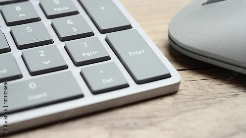 Finger pressing the enter key close up Finger pressing the enter key close up