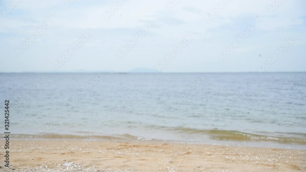 Tropical beach with white sand and blue sea in summer time on sunny day. Sea peaceful beach scenery foamy wave on the beach with waves of blue sea tropical ocean sand. travel vacation seaside. Tropical beach with white sand and blue sea in summer time on sunny day. Sea peaceful beach scenery foamy wave on the beach with waves of blue sea tropical ocean sand. travel vacation seaside.