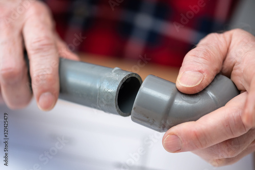 Fotografija Plumber joining pvc pipes