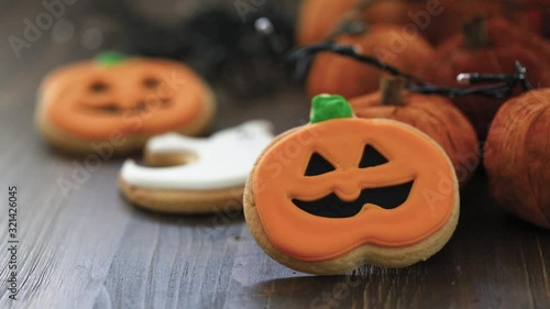 Halloween cookies with light on brown wooden background