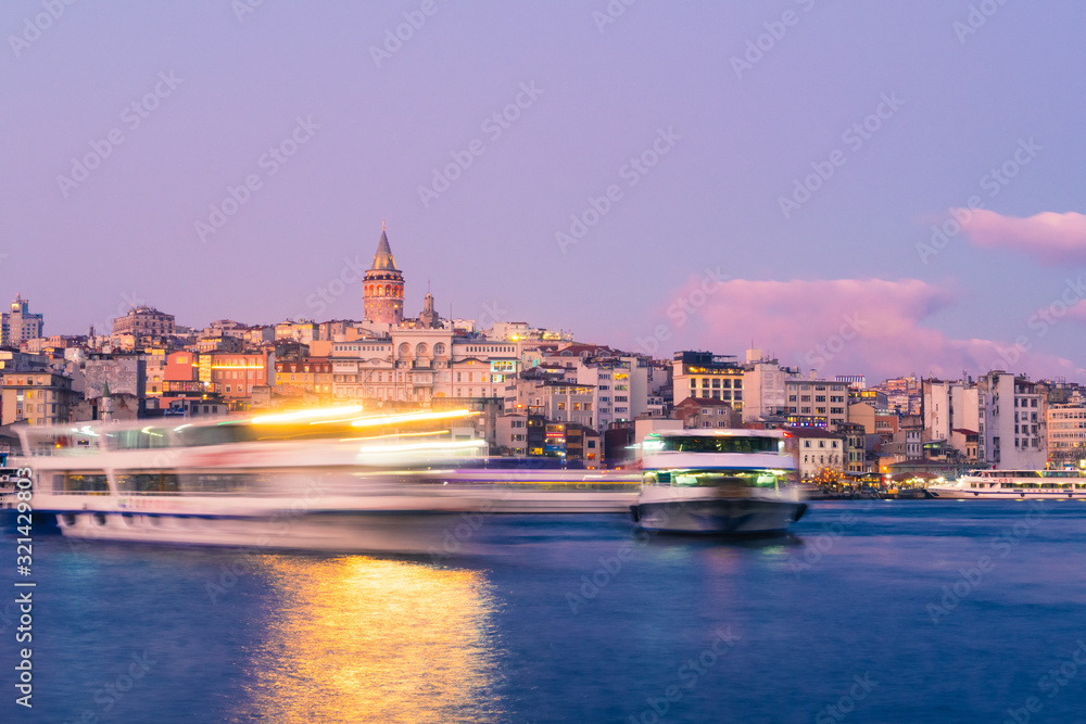 Naklejka premium Istanbul, Turkey - Jan 15, 2020: Galata Tower with Ferry Boat in Golden Horn , Istanbul, Turkey,