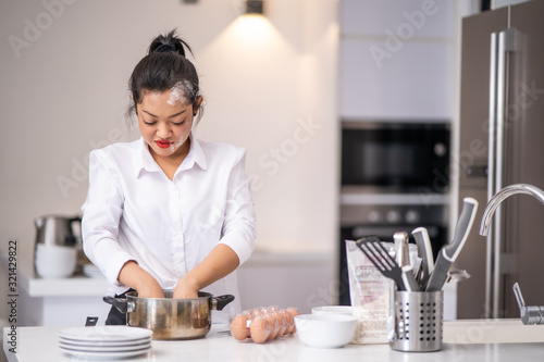 The woman was preparing flour in a bowl