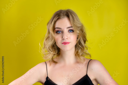 Wallpaper Mural Glamorous beauty front view portrait of a pretty model with blond hair with great makeup and a beautiful hairstyle on a yellow background in the studio. The concept of cosmetics, fashion and style. Torontodigital.ca