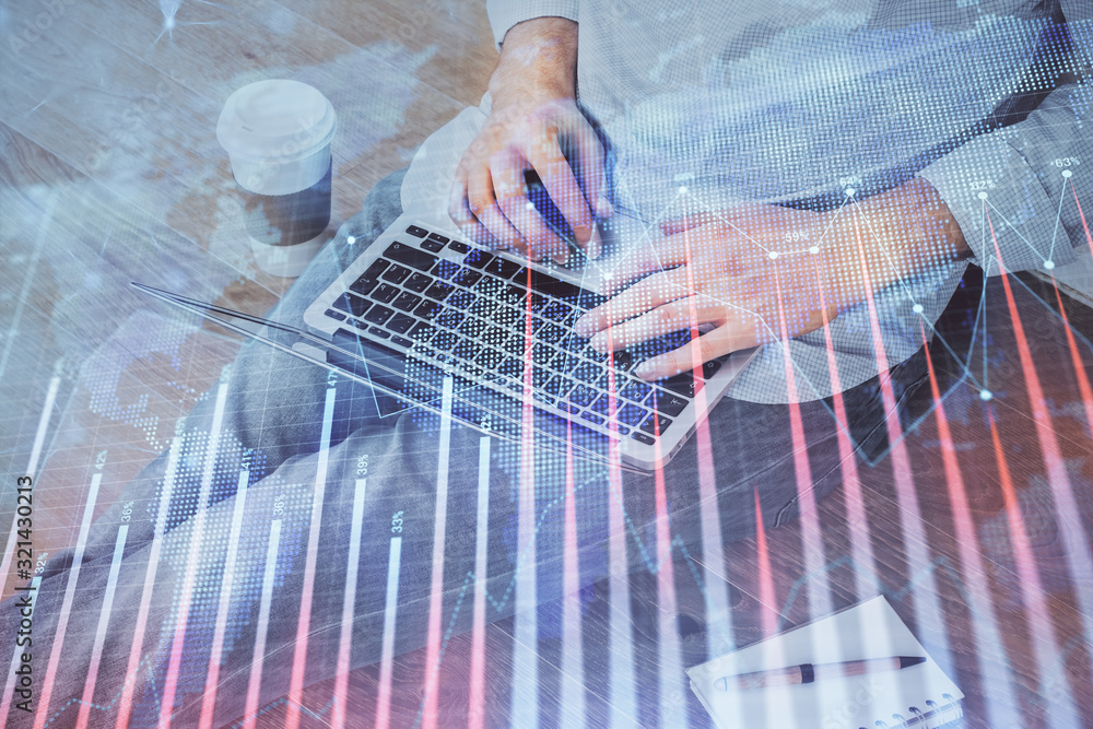 Forex graph with businessman working on computer in office on background. Concept of analysis. Double exposure.