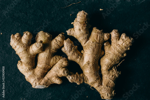 Close up view of ginger root on slate background, top view.  photo