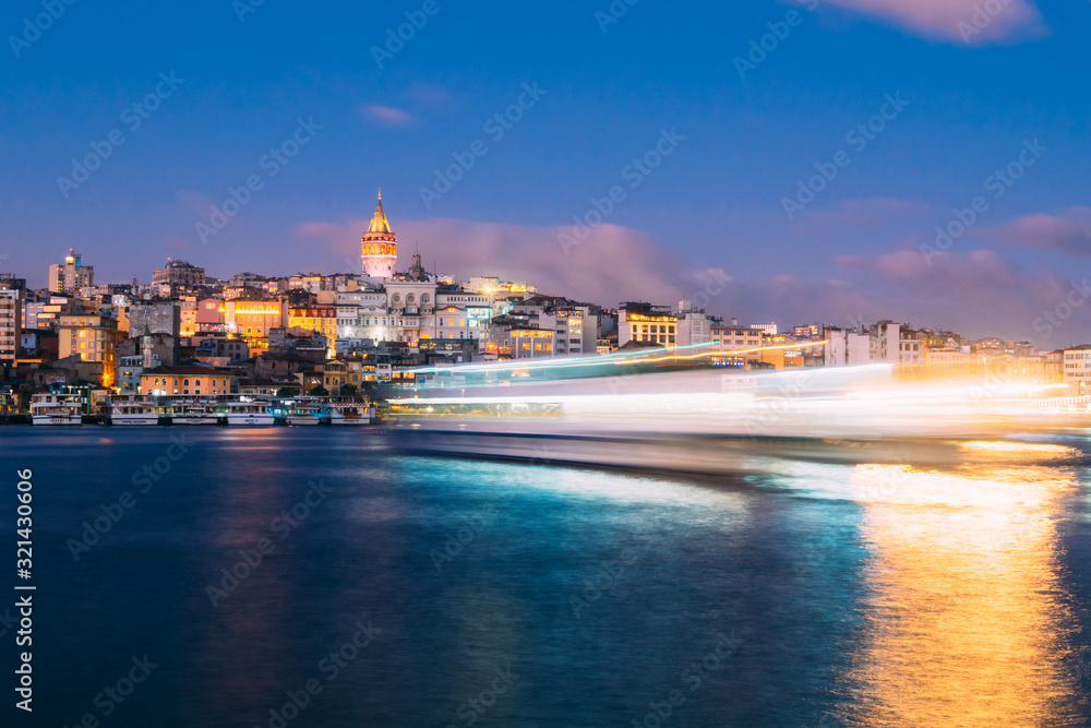 Istanbul, Turkey - Jan 15, 2020: Galata Tower with Ferry Boat in Golden Horn , Istanbul, Turkey,