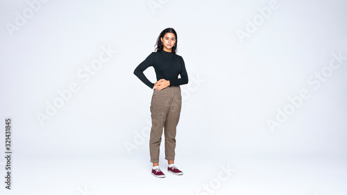 Young woman standing with hands on waist photo