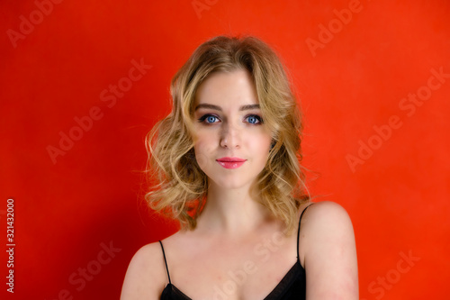 Wallpaper Mural Glamorous beauty front view portrait of a pretty model with blond hair with great makeup and a beautiful hairstyle on a red background in the studio. The concept of cosmetics, fashion and style. Torontodigital.ca